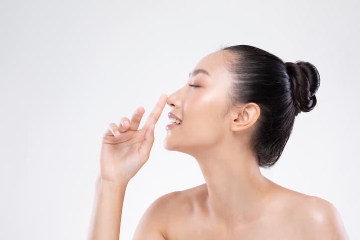 Beautiful Asian woman touching nose smile with clean and fresh skin Happiness and cheerful with positive emotional,isolated on white background,Beauty and Cosmetics Concept