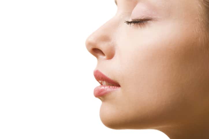 Close up side portrait of a young woman with her eyes closed