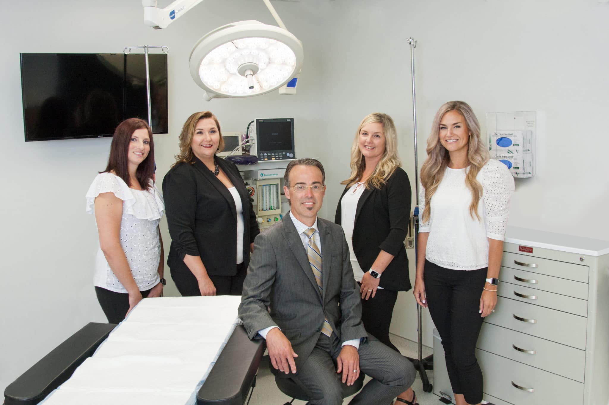 Dr. Chad Tattini, M.D. with team of staff