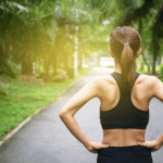 Back view of young fitness woman running on the road in the morning.