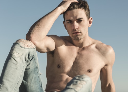 Sexy,Topless,Handsome,Male,Model,Posing,Against,Blue,Sky.